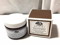 Photo showing the cream jar beside its original box, displaying the product label and branding clearly.