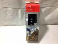 Photo of the retail packaging showing the Joby GorillaPod Action Series tripod box featuring an image of a cyclist using the tripod on a rock.