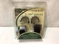 Front view of the unopened package showing Weaver Gloss Black Top Mount rings in plastic sealed packaging with product details: 1 inch high dual extension fitting up to 44mm objective lens.