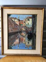 Full view of framed Venetian canal painting showing arched bridge and reflections