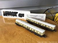 Photo of two passenger cars and locomotive tender out of box