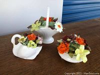 Three Royal Adderley porcelain floral figurines on a wooden surface, including a basket, swan, and bowl, showing full lot