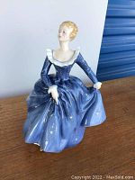 Front view of the Royal Doulton figurine showing detailed blue gown and ruffled white collar.