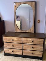 Full front view of Bassett dresser with mirror showing the wood laminate surfaces and drawer pulls.