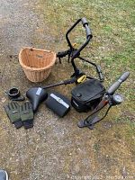 Full view of the lot showing bike rack, wicker basket, two Cannondale bags, Topeak pump, black bicycle seat, gloves, lock cable and black pouch.