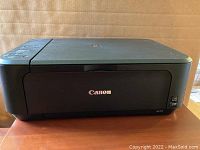 Front view of the Canon Pixma printer showing the closed unit with Canon logo and wireless print capability logo.