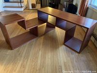 Two shelving units arranged in modular configuration on hardwood floor