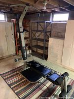 Full view of Schwinn Comp Bowflex gym with padded bench, vertical tower, and cable pulleys.