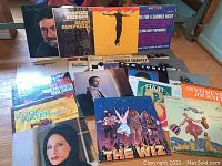 Photo showing a mix of 15 vintage vinyl LP records with variety of album covers and genres.