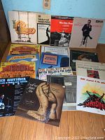Vintage vinyl LP records laid out showing various album covers including Chicago, The Best of Herbie Mann, West Side Story, Shelley Berman, Celebrate Life, and others