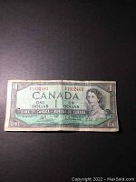 Front side of a 1954 Canadian one dollar banknote with visible wear and tear, creasing, and discoloration.