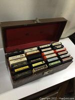 Open case revealing 17 assorted older 8 track tapes with mixed genres in visibly worn condition.