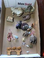 Full tray showing all elephant figurines of various materials and sizes