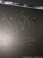 Overview photo showing all gold jewelry pieces including chain segments, clasps, and the ring.