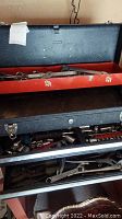 Top drawer with red tray holding various wrenches including combination and open-end types.