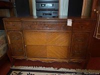 Front view of the dresser showing the entire piece with three drawers, veneer wood finish, and decorative inlay trim.