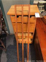 Front view of wooden cabinet stand with multiple drawers and storage compartments.