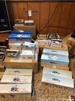 Overview of sealed model boxes including cars, helicopters, and motorcycles.