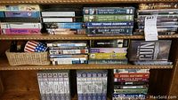 Overview of multiple shelves containing VHS tapes and DVDs on various topics including American Civil War, railroads, and military history.