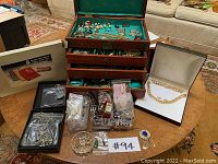 Overall lot with open wooden jewelry box, travel organizer, loose jewelry in plastic trays and boxed 10K gold chain