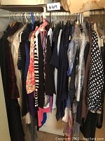 Full rack of assorted women's clothing on hangers