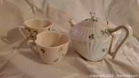 Full set photographed - one tea pot with spout chip and two matching tea cups with shamrock motif.