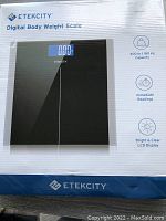 Front view of the Etekcity digital body weight scale box showing the black scale and key product features like 400 lb capacity, immediate readings, and bright LCD display.