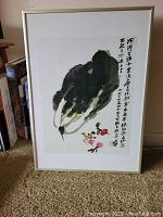 Framed print showing traditional Chinese ink painting of bok choy and radishes with accompanying calligraphy, set against a white mat and simple white frame.