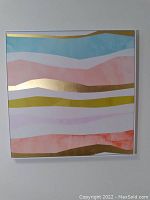 Front view of square canvas artwork with horizontal irregular stripes in pastel colors and gold accents.