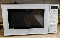 Front view of Panasonic white microwave oven NN-SD664W showing door and control panel.