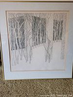Framed etching titled "First Snow" showing leafless trees and window-like shapes in black and white with artist's signature and numbering visible on bottom.