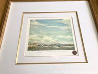 Framed limited edition Tom Thomson print showing full view of artwork, mat, frame