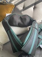 Photo showing black and dark green Tru-Medic Insta-Shiatsu electric neck and back massager with visible control buttons and padded mesh section.