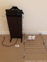 Full side view of the Corby trouser press with shoe racks on carpeted floor.