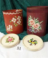 Photo showing two vintage hand-painted toleware oval waste cans and eight 7-inch round trays with rose and rooster designs arranged for display.
