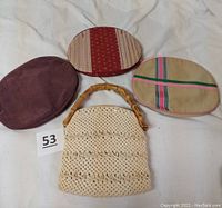 Photo showing the purse body with bamboo handle and all four oval cloth covers laid out.