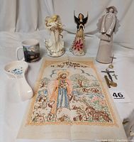 Full lot including porcelain angels, ceramic angels, mug, wall hanging, spoon rest, crucifixes, and small flashlight