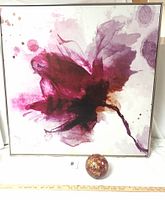 Full view of maroon blossom artwork with silver frame and mosaic sphere in front for scale.