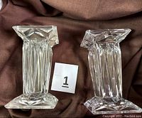 Two views showing the reversible crystal pedestal with quad prism faceted design and square base and top
