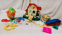 Full lot view showing Mr. Potato Head with accessories, Chicco activity center, Play-Doh Fun Factory pieces including extruder and molds