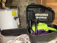 Poulan Wild Thing gas chainsaw in open black carrying case showing 18 inch bar with protective cover and overall saw body.