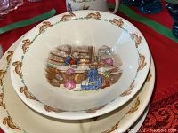 Close-up image of one of the Bunnykins bowls showing bunny bakery scene inside with bunny motif border.
