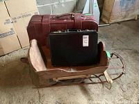 Photo of the vinyl suitcase, leather briefcase, and vintage wood sled placed together showing size and condition.