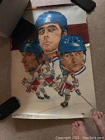 Poster of the USSR hockey team from 1976 Canada Cup showing illustrated player portraits in helmets, signed CCCP and Soviet emblem, with some wear visible.