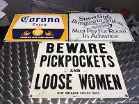 Three metal signs displayed on metallic surface, showing all signs together for scale and layout.