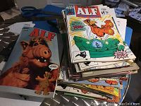 Stack of Marvel ALF comics and specials showing colorful comic book covers