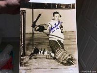 Photo of signed black and white 11x14 Harry Lumley hockey photograph on ice in Toronto Maple Leafs uniform, showing autograph in blue ink.