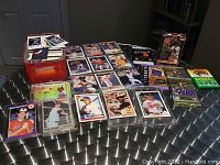 Overview photo showing tin, loose cards, wax packs, and star set cards in sleeves spread on table