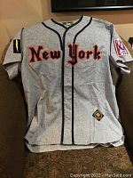 Front view of gray wool baseball jersey with 'New York' embroidered and sleeve patches.