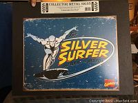 Metal Silver Surfer collector sign with Marvel Comics branding and distressed finish.